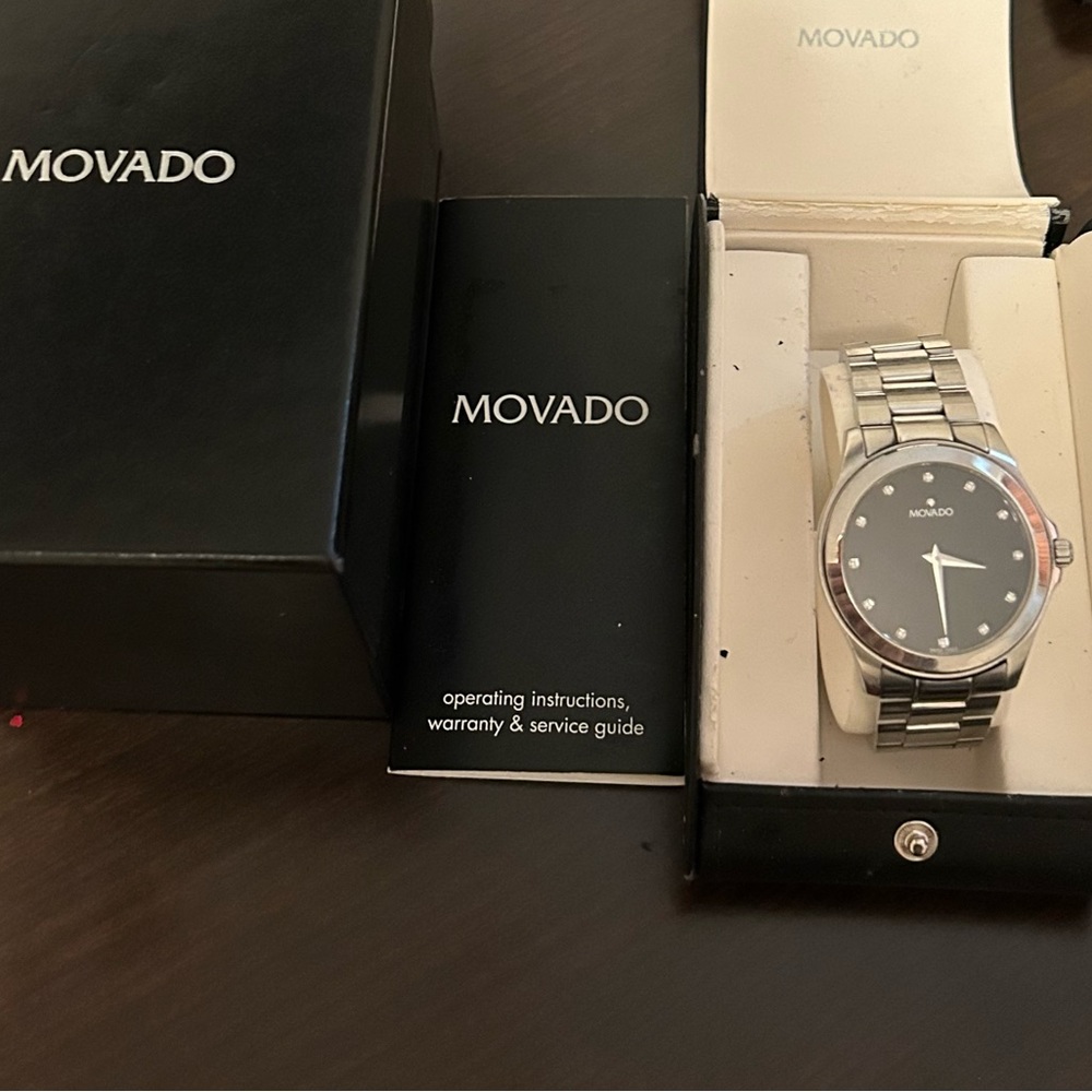 Men’s stainless steel movado watch with original box papers and extra links